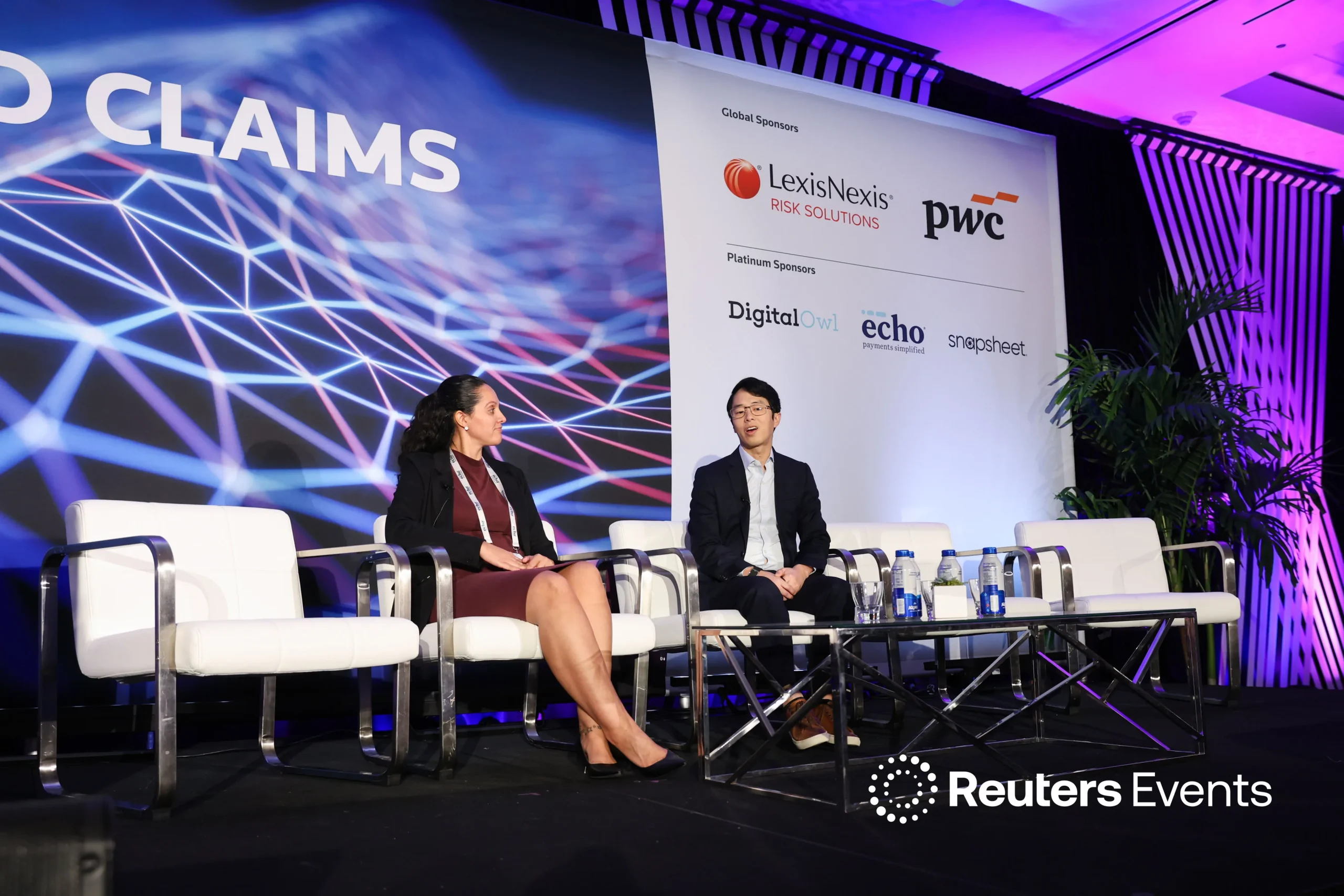 Voltaire team member in conversation on a Reuters Events Connected Claims stage