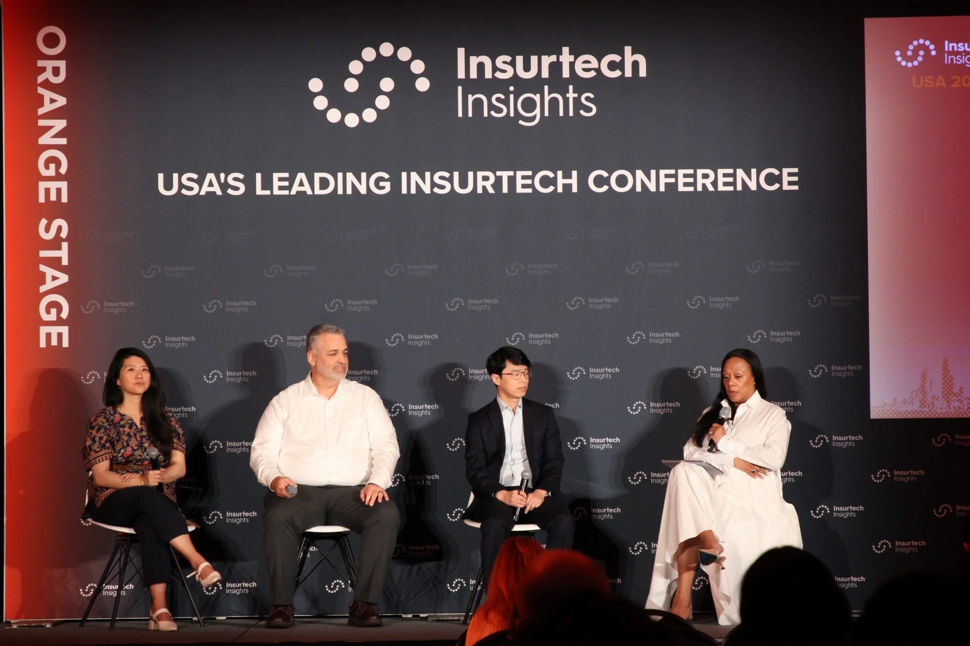 Panelists seated on stage at Insurtech Insights