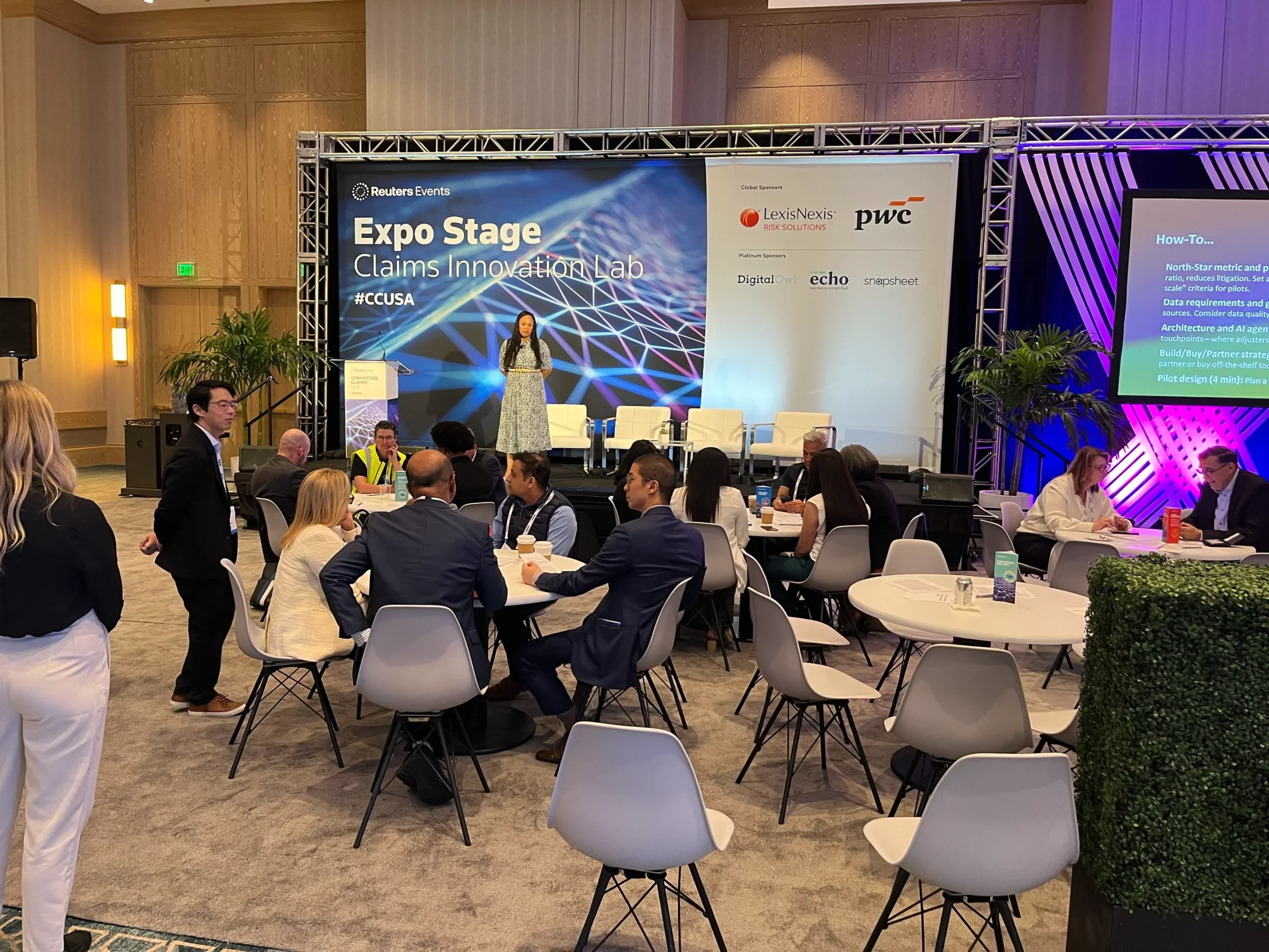 Insurance event attendees seated in chairs at a Connected Claims innovation lab